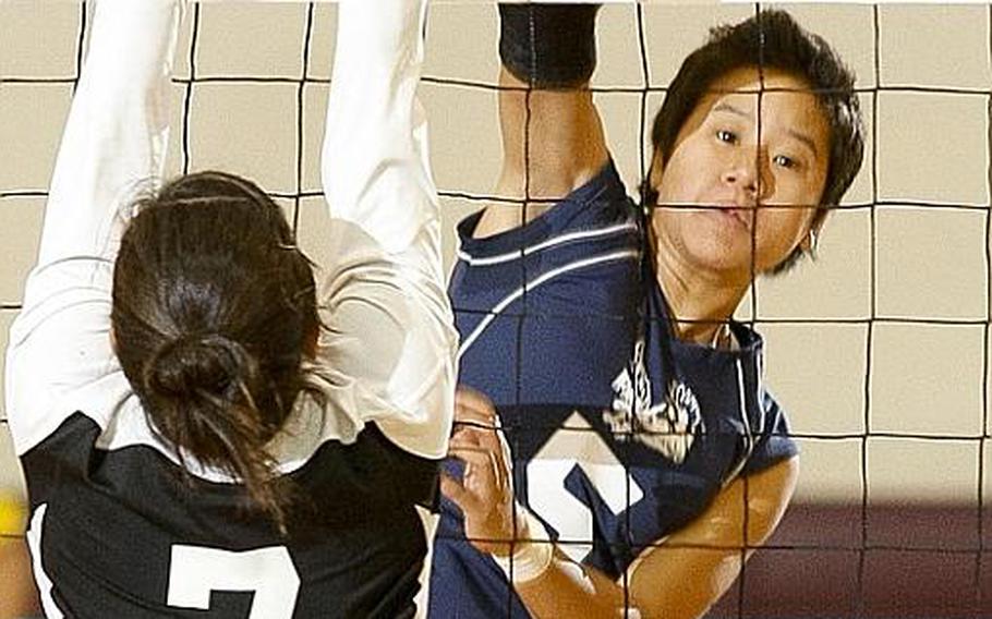 Seoul American's Liz Gleaves blasts a spike kill past Regina Shiroma of Simon Sanchez during Tuesday's division-play match in the Far East High School Girls Division I Volleyball Tournament at Super Gym, Camp Humphreys, South Korea. Seoul American won, 25-14, 25-12.
