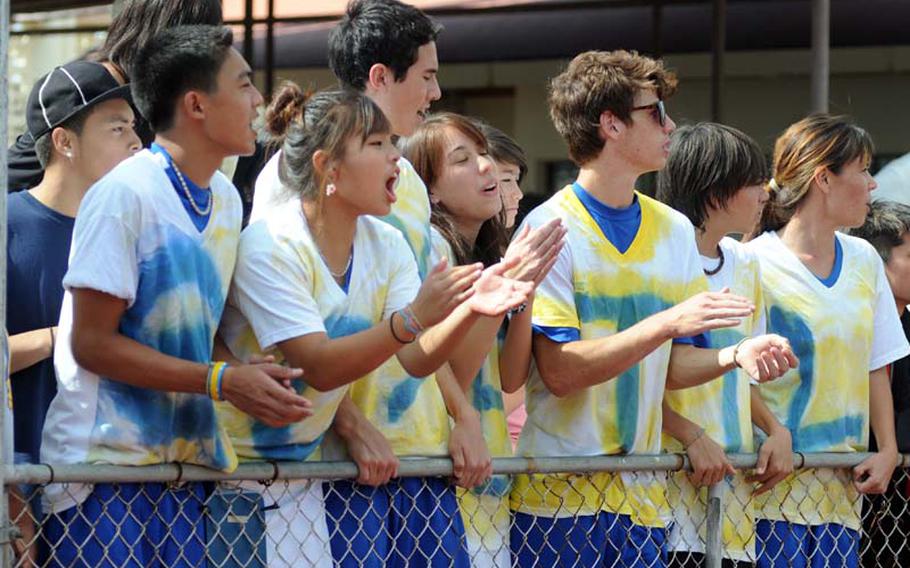 Yokota Panthers teammates cheer on junior singles player Erika Ettl with T-shirts that spell out GO (heart) ETTL during Wednesday;s girls singles semifinal match against Kadena sophomore and former Yokota teammate Erika Youngdahl in the Far East High School Tennis Tournament at Risner Tennis Complex, Kadena Air Base, Okinawa. Ettl won, 6-2, 6-4.