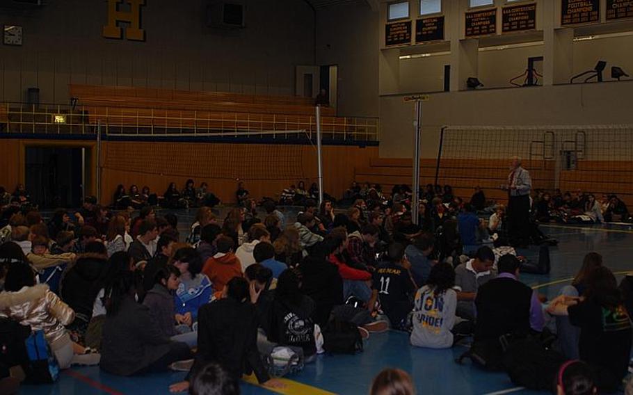 Heidelberg High School principal KJ Brewer, right, addresses students and some parents assembled in the high school gym Friday morning to protest the decision to remove teacher Brad Shahan from coaching the Lions' football and basketball teams. Brewer said before the session that he planned to listen to the concerns of the students, who sat on the gym floor, and that the assembly would be ''a civics lesson.''