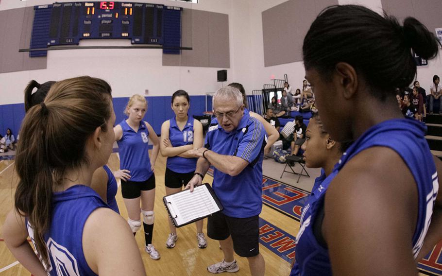 Denny Hilgar, the 31-year head coach of Seoul American&#39;s girls volleyball team, talks to his charges during a timeout. His 2010 team sent him off with the perfect ending to his coaching career, his first and only Far East Division I Tournament title.
Coach Hilgar and SAHS Team during time out.