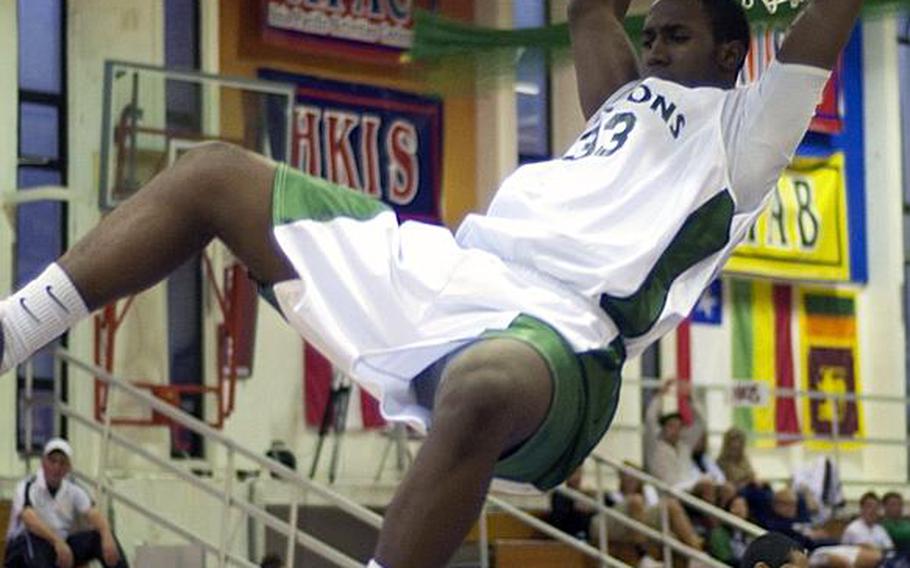 Kubasaki Dragons senior Kentrell Key finishes off a slam dunk during Friday's single-elimination playoff game in the 41st Hong Kong International School Holiday Basketball Tournament at Hong Kong International School, Red Hill Road, Tai Tam, The play was negated because of a traveling call. Kubasaki won, 67-30, in a rematch of last February's Far East Division I Tournament slowdown playoff game which St. Mary's won, 12-11.