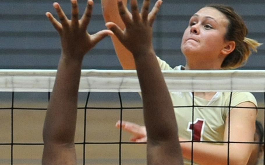 Vilseck's Anna Muzzy slams the ball over the net as Kaiserslautern's Courtney Woods defends during the DODDS-Europe volleyball tournament. Muzzy was named the Starts and Stripes' volleyball player of the year for Europe.