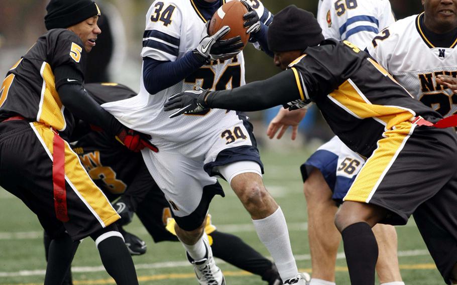 Phillip Lamb of Navy tries to slice between Army defenders Ametrius Shaw and Jamal Smith during Saturday's Army-Navy flag football game at Sims Field, Seoul American High School, South Korea. Army prevailed over Navy 12-6 in overtime.