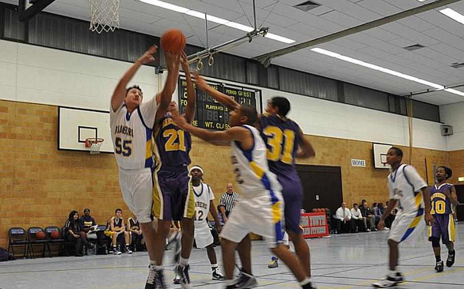 Mannheim and Bamberg players go up for a rebound in Friday night's season opener. Bamberg went on to win the game, 43-38, against visiting Mannheim.