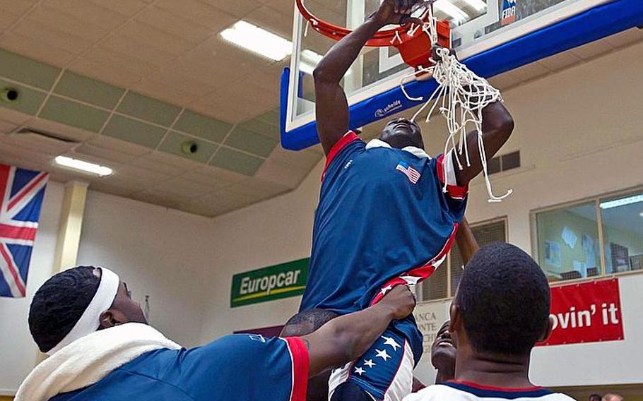 Members of the U.S. Armed Forces team cut down the net after winning the 47th SHAPE International Basketball Tournament on Saturday. The U.S. beat the Lithuania, the defending champions, 78-71.