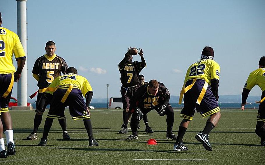 Abifarin Scott takes the snap deep in Navy territory during a 26-19 win over Navy on Saturday at Yokosuka Naval Base in the annual Army-Navy flag football game pitting soldiers against sailors stationed on mainland Japan.