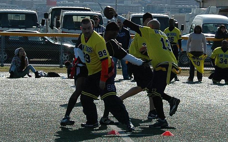 Navy quarterback Anthony Seaman tries to reach for a first down Saturday during his team's 26-19 loss to Army in the annual flag football game between soldiers and sailors stationed in mainland Japan, held at Yokosuka Naval Base.