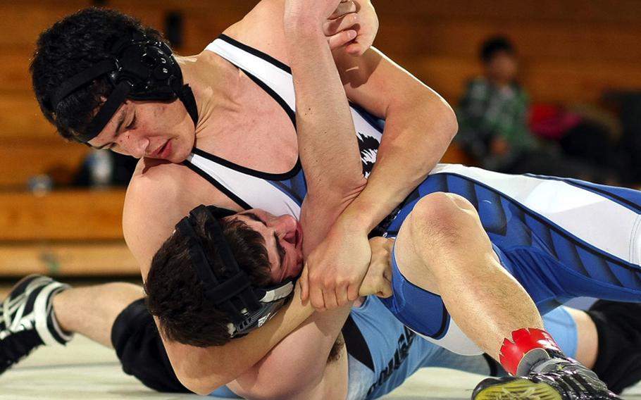 Bryan Hathaway of Seoul American gets Kyle Tarvin of Osan American in a head-in-arm hold during Saturday's 148-pound bout in a DODDS Korea wrestling tri-meet at Seoul American High School, South Korea. Hathaway pinned Tarvin in 3 minutes, 29 seconds and Seoul American won the dual meet, 41-6.