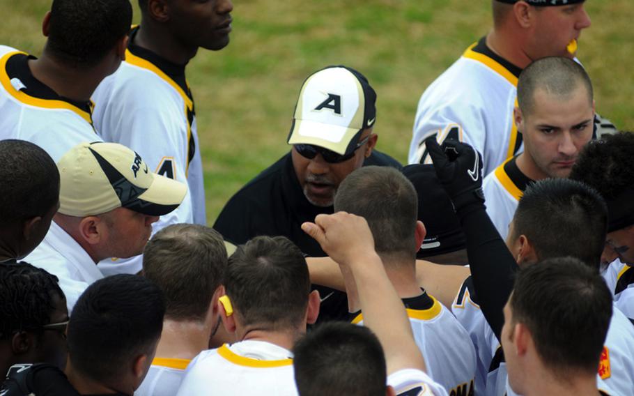 Army coach Lawrence Occomy gathers his charges for a pep talk just before Saturday's Army-Navy flag football game at Torii Field, Torii Station, Okinawa. Navy broke a six-year losing streak in the 21-year-old series, beating Army, 27-3.