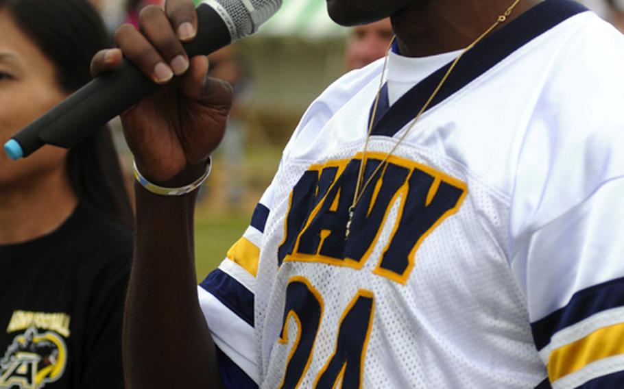 Terry Woodcock sings the national anthem before Saturday's Army-Navy flag football game at Torii Field, Torii Station, Okinawa. Navy broke a six-year losing streak in the 21-year-old series, beating Army, 27-3.