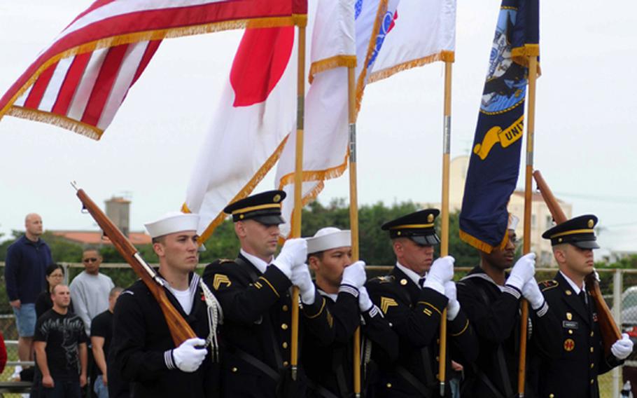 The joint-service color guard parades the colors onto the field before Saturday's Army-Navy flag football game at Torii Field, Torii Station, Okinawa. Navy broke a six-year losing streak in the 21-year-old series, beating Army, 27-3.