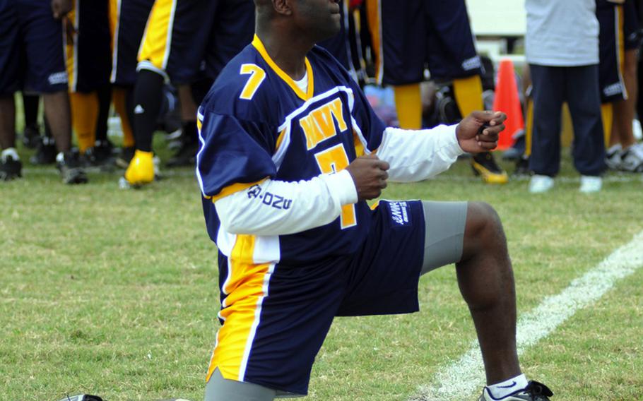 Navy quarterback Robert Trisby feigns gunfire at his Army opponents during lineup introductions prior to Saturday's Army-Navy flag football game at Torii Field, Torii Station, Okinawa. Navy broke a six-year losing streak in the 21-year-old series, beating Army, 27-3.