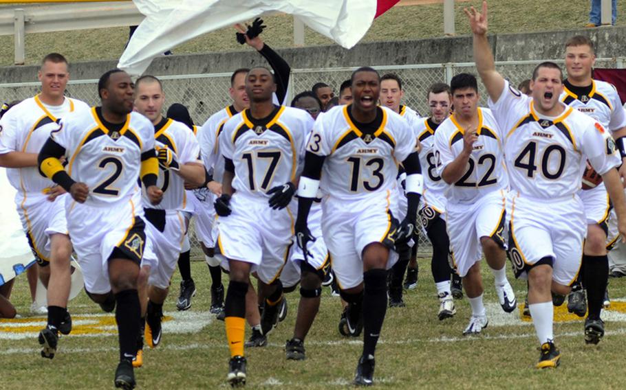Army charges onto the field prior to Saturday's Army-Navy flag football game at Torii Field, Torii Station, Okinawa. Navy broke a six-year losing streak in the 21-year-old series, beating Army, 27-3.