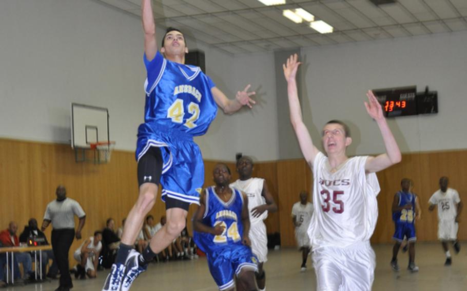 Ansbach junior Herivan Figueroa drives for a layup Saturday during the Cougars' 62-52 win over visiting Baumholder. Figueroa scored 14 points, collected 6 rebounds, and had 5 steals in the Cougars' first win of the season. Baumholder won Friday night's game in Ansbach, 79-72.