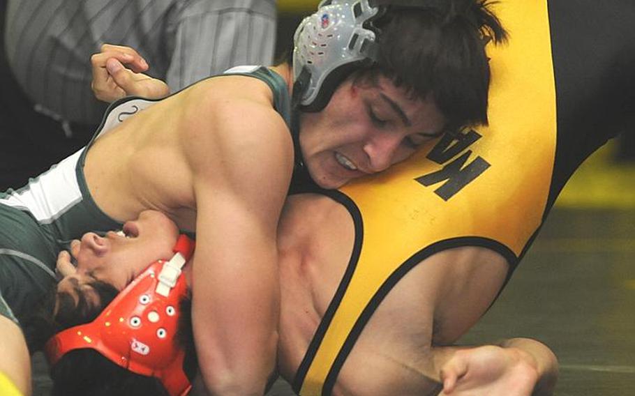 Kubasaki's Mark Chase glues Kadena's Chris Shapiro-Kinghorn's shoulders to the mat during Thursday's 129-pound bout in the Okinawa Activities Council dual meet at Kadena High School, Okinawa. Chase pinned Shapiro-Kinghorn in 1 minute, 26 seconds and Kubasaki won the dual meet, 36-28.
