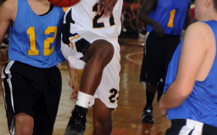 Kadena High School sophomore Shawn Broughton drives to the basket against the U.S. Naval Hospital Camp Lester Bang defense during Saturday's pool play in the 17th Martin Luther King Invitational Basketball Tournament at Camp Foster, Okinawa. Kadena won, 46-34.