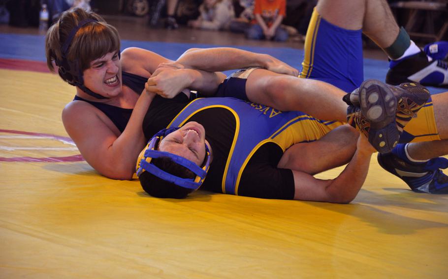 Heidelberg freshman Justin Vatcher tries to lock the arm of Ansbach senior Richy Vago during the first match of the day  in Ansbach. Vatcher went on to win the match.