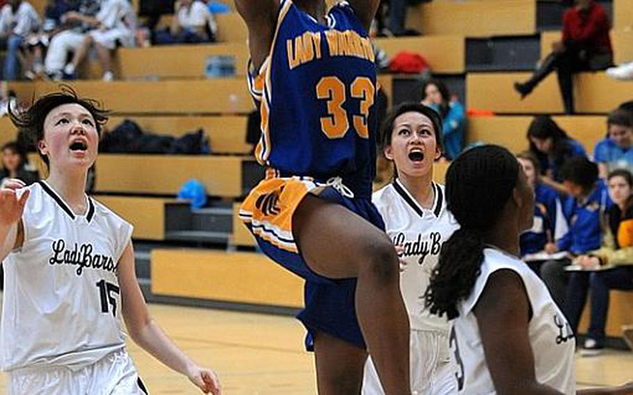 Wiesbaden's Kelley Colbert ends a fast break with a bucket against Bitburg defenders Michelle Morrison, Dawn Valbuena and Lamonica Williams, from left. Wiesbaden defeated Bitburg, 44-12, at home on Saturday.