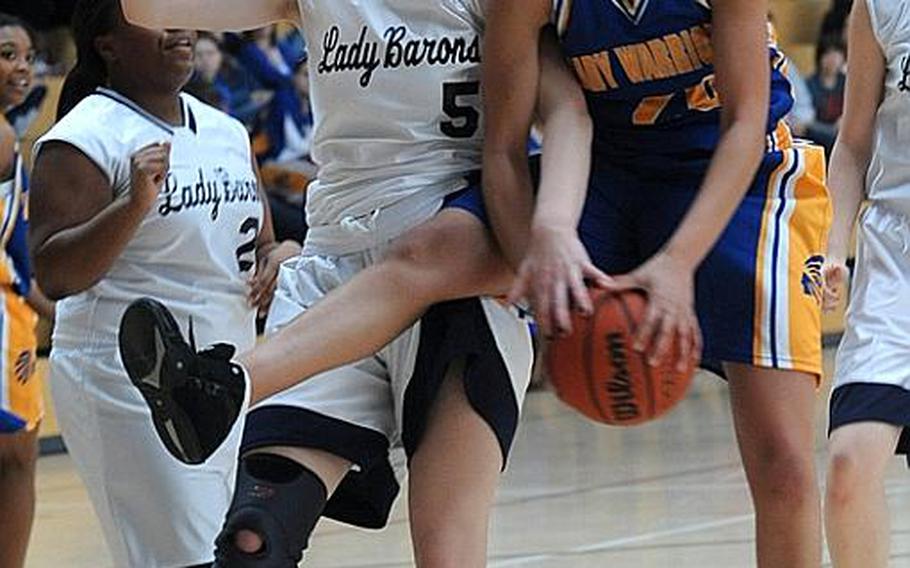 Bitburg's Melissa Menschel, left, and Wiesbaden's LeAndra Thomas fight for a rebound in a game in Wiesbaden on Saturday. Wiesbaden won, 44-12, as Thomas recorded a triple-double: 12 points, 13 rebounds and 10 steals.