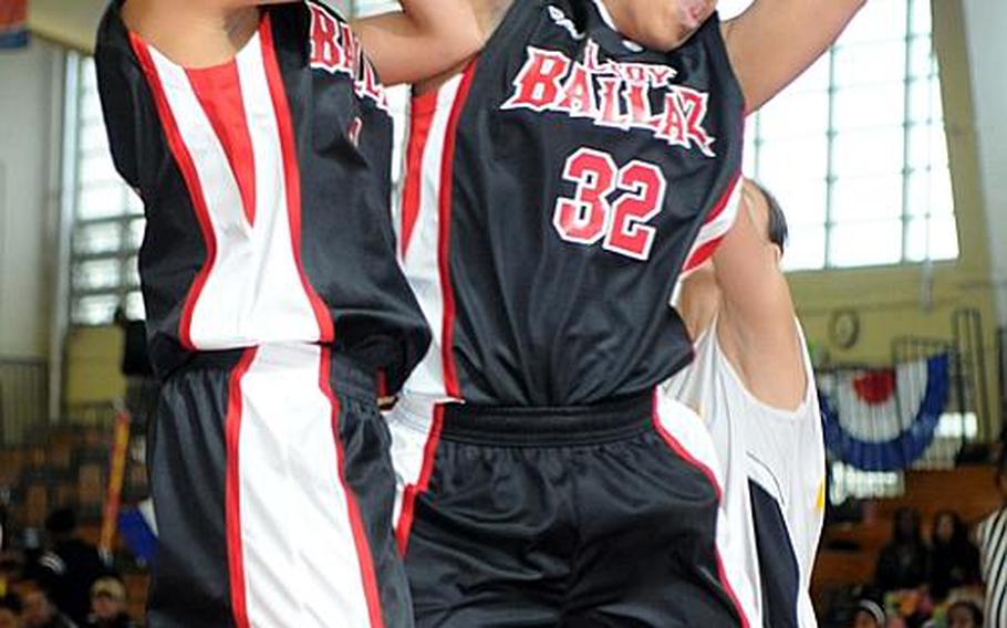 Kimberly Olton of Lady Ballaz grabs a rebound in front of Kadena High School's Ashley Buckley as teammate Charmain Walker, left, looks to help  during Sunday's double-elimination championship bracket game in the 17th Martin Luther King Invitational Basketball Tournament at Camp Foster, Okinawa. Lady Ballaz beat Kadena High, 65-18, hours after the Panthers beat the aircraft carrier USS George Washington, 87-86 in triple-overtime, the highest-scoring women's game in Foster Field House history.