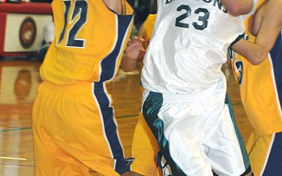 Kubasaki Dragons guard Kai Yamaguchi knifes his way through two Kitanakagusuku defenders during Friday's pool-play game in the 5th Okinawa-American Shootout high school basketball tournament at Camp Foster, Okinawa. The Dragons edged the Fighting Lions, 39-37.