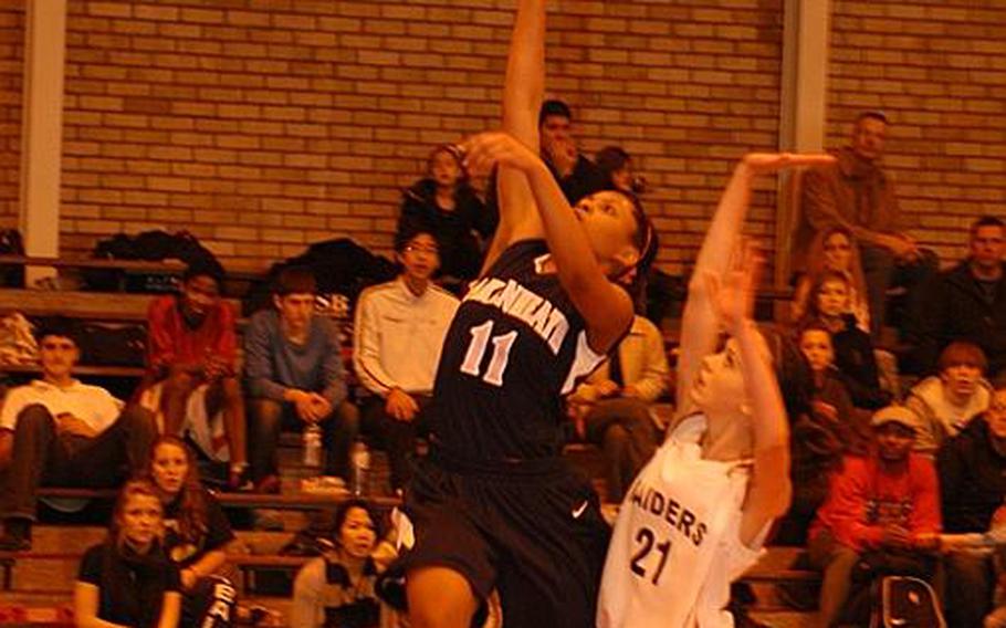 Lakenheath's Shaionica Speight flies past International School of Brussels defender Alison Galetti for a layup during a 40-21 Lakenheath victory on Saturday.