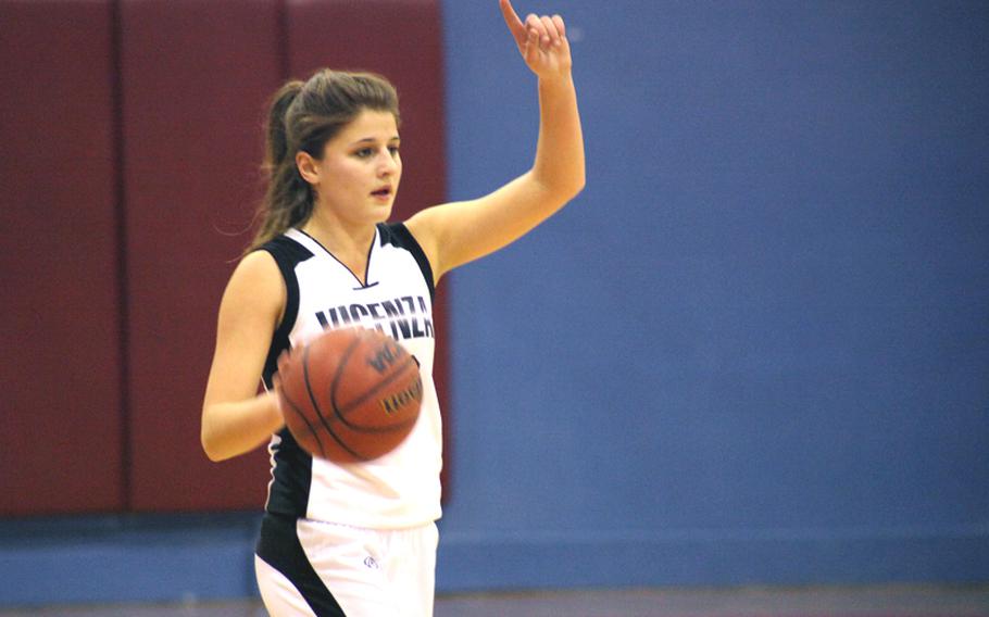 Republic of Georgia native Lali Baratashvili slips into her leadership role as a Lady Cougars co-captain by signaling a play during a girls basketball game in Vicenza, Italy.