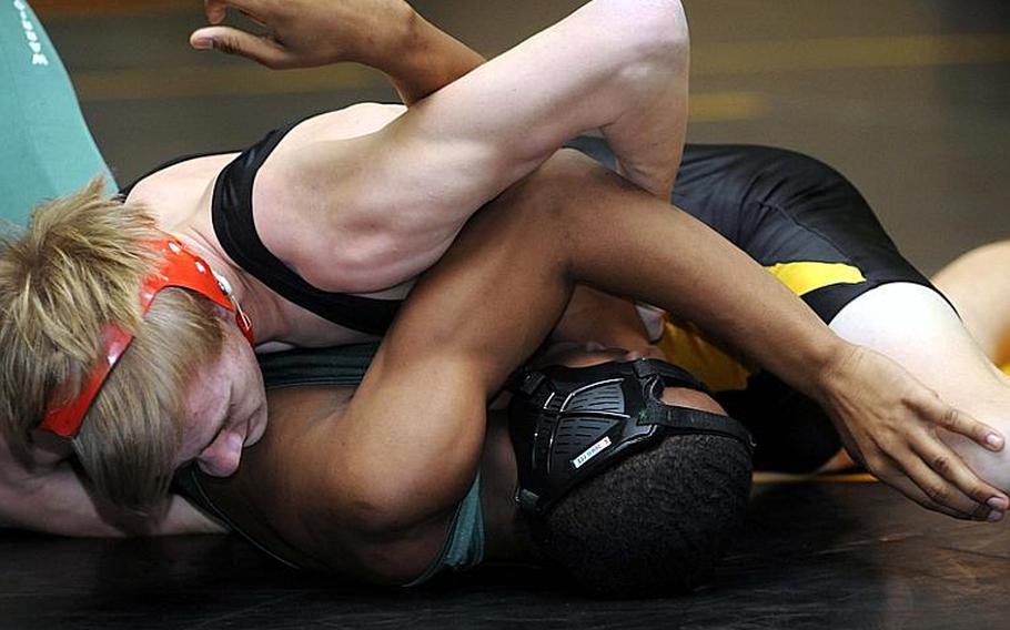 Kadena's Jacob Bishop, top, uses a chest press against Daegu American's Xavian Washburn during Friday's 148-pound bout in the dual-meet portion of the 4th Rumble on the Rock high school wrestling tournament at Kubasaki High School,  Okinawa. Bishop won by technical fall 2-0 (7-1, 6-0).