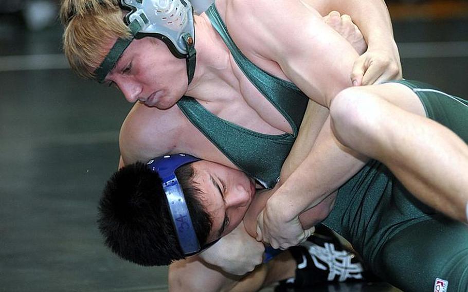Kubasaki's Jon Goddard, top, catches Seoul American's David Chong in a head-in-arm hold for a pin during Friday's 141-pound bout in the dual-meet portion of the 4th Rumble on the Rock high school wrestling tournament at Kubasaki High School, Okinawa. Goddard won in 1 minute, 17 seconds, and Kubasaki won the dual meet, 39-19.
