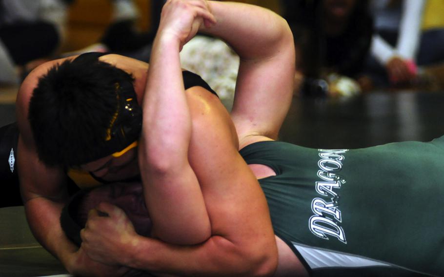Kadena's Aaron Ahner, top, puts the finishing touches on a pinfall victory over Kubasaki's Jacob Wood during Saturday's 215-pound championship bout in the 4th Rumble on the Rock Wrestling Tournament at Kubasaki High School, Okinawa. Ahner won by pin in 5 minutes, 23 seconds and Kadena won its third straight individual freestyle team title.