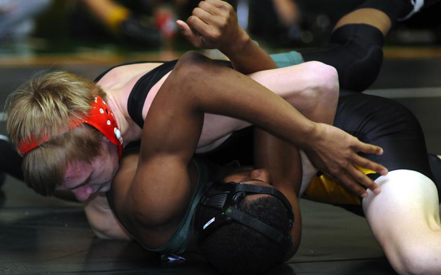 Kadena's Jacob Bishop, top, puts the finishing touches on a pinfall victory over Daegu American's Xavian Washburn during Saturday's 148-pound championship bout in the 4th Rumble on the Rock Wrestling Tournament at Kubasaki High School,  Okinawa. Bishop pinned Washburn in 1 minute, 27 seconds and Kadena won its third straight individual freestyle team title.