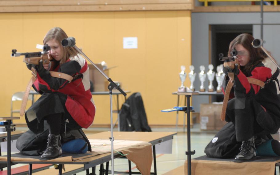 Vilseck sophomores Malia Carson, left, and Christy Chanin get their precision air rifles adjusted before taking aim at Saturday's 2011 DODDS-Europe marksmanship championships at Baumholder High School.  Chanin led all shooters in the prone position scoring 99 points out of a possible 100 as Vilseck took second in the tournament.