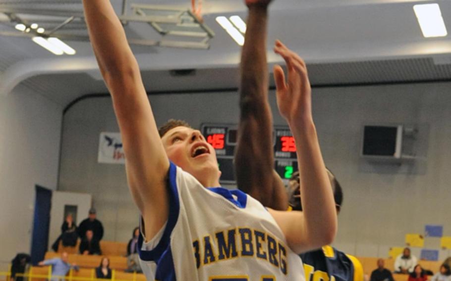 Bamberg's Dillon Luedtke goes in for a basket against Heidelberg's Eugene Jones. Heidelberg rebounded from its first loss of the season Friday night, to defeat the Barons, 67-47, on Saturday.