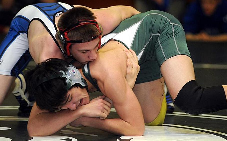 Seoul American Falcons junior 129-pound wrestler Robert Rhea, top, works toward a victory by decision over Kubasaki's Mark Chase in Saturday's gold-medal bout in the 4th Rumble on the Rock wrestling tournament at Kubasaki High School, Okinawa. Rhea won the Peninsula District 125-pound gold last year out of Denbigh High in Newport News, Va., wrestling more than 40 bouts over a four-month span. Prior to the Rumble, Rhea had four bouts this season - all against the same opponent.