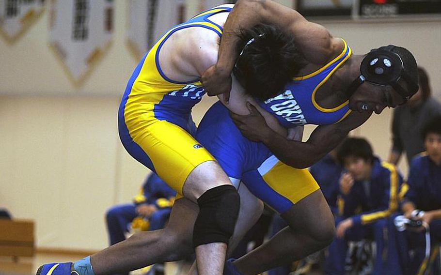 Yokota's Devin Day locks in a head-in-arm hold on Koki Fujiwara of St. Marys International during Wednesday's 135-pound bout in the Kanto Plain Association of Secondary Schools' regular-season finale at St. Mary's International School, Tokyo. Day pinned Fujiwara in 1 minute, 56 seconds, but St. Mary's beat Yokota, 38-25, to force a three-way tie atop the Kanto final regular-season standings with Zama American at 4-1.