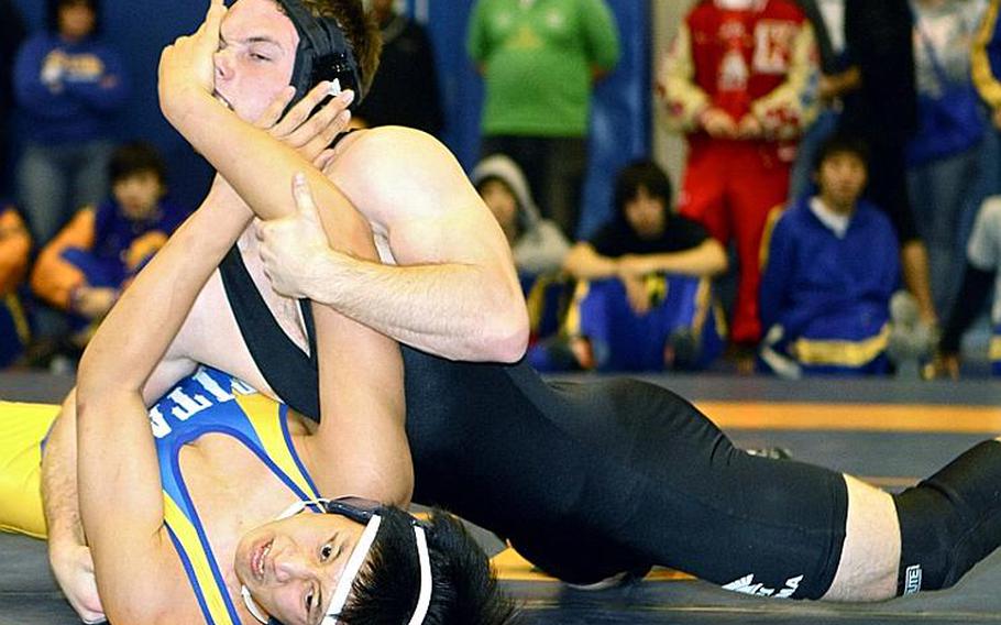 Jeffrey Koo of St. Mary's International, bottom, tries to fend off two-time Far East champion Michael Spencer of Zama American during the 168-pound championship bout in the 38th Kanto Plain Association of Secondary Schools Wrestling Tournament at Yokota High School, Japan, earlier this season.