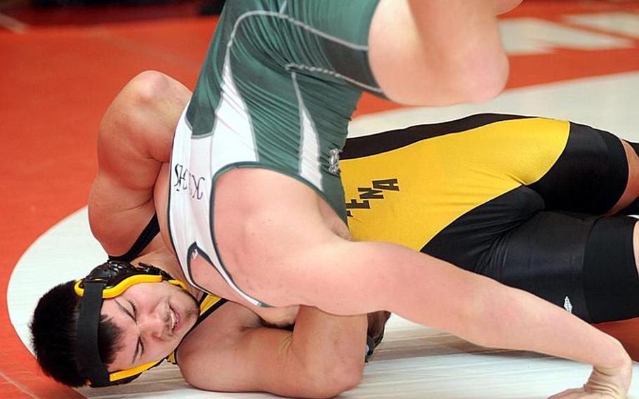 Aaron Ahner of Kadena tilts Kubasaki's Jacob Wood onto his head during the 215-pound final in the Nile C. Kinnick Invitational "Beast of the Far East" Wrestling Tournament at Nile C. Kinnick High School earlier this season.