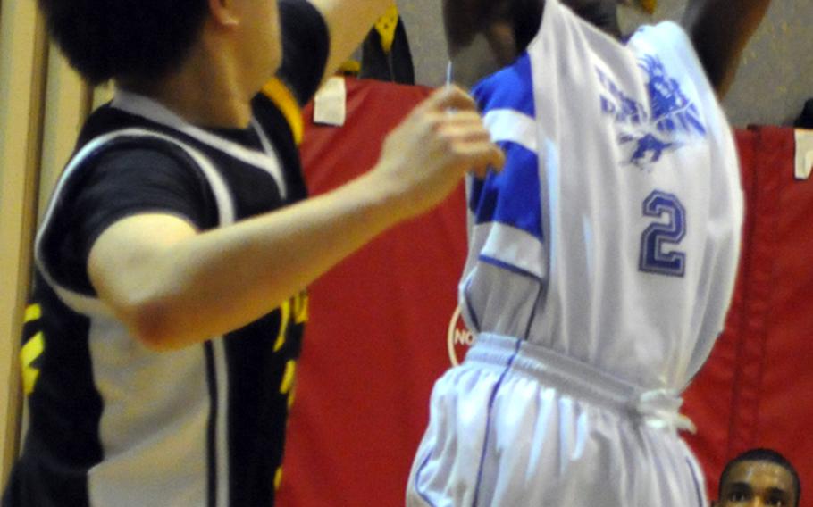 Seoul American's D.J. Lawrence shoots against Taejon Christian International's Jason Lee during Friday's game in the 2011 Korean-American Interscholastic Activities Conference Boys Division I Basketball Tournament at Gyeonggi Suwon International School, South Korea. Seoul American routed TCIS, 80-49.