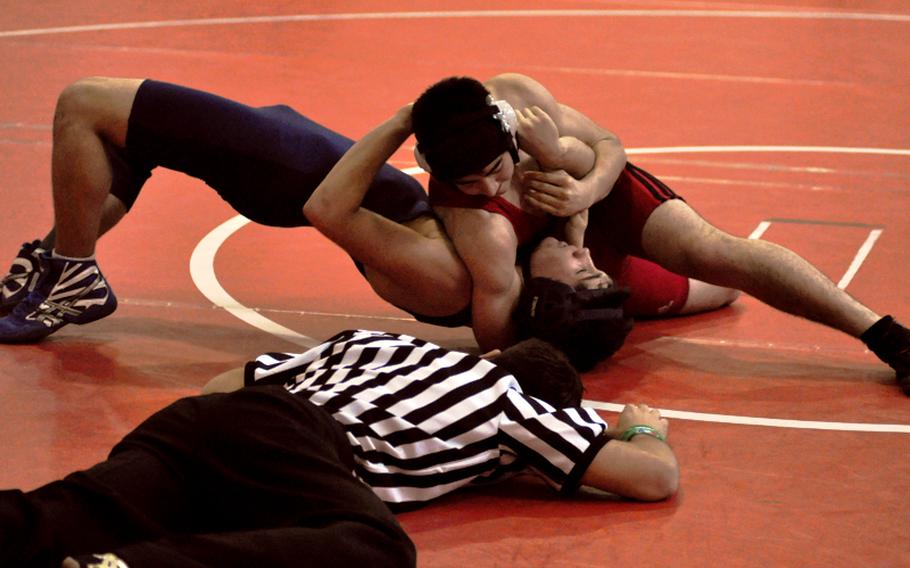 Aviano's Andy Kunis scores near-fall points against Josh McKeown of Black Forest Academy during a 140-pound semifinal match Saturday at the DODDS Europe Southern Region wrestling tournament at Aviano High School in Italy. Kunis pinned McKeown a few seconds later and advanced to the finals.