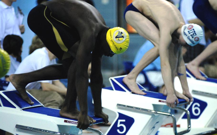 James Jones, left, of the Vicenza Mako Sharks prepares for the start of the boys 13- and 14-year old 100-meter butterfly event at the 2011 European Forces Swim League championships at Eindhoven, Netherlands.  Jones won the event.  Peter Cummin, 14, from the Kaiserslautern Kingfish is at right