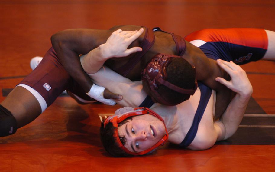 Baumholder wrestler Prince Owusu, top, tries to pin Lakenheath's Joey Connor in the 145-pound weight division at the DODDS-Europe Northern Sectionals.