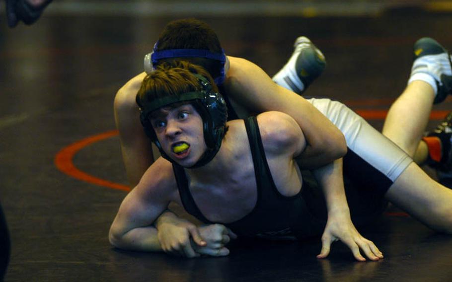 SHAPE wrestler Cody Moose, bottom, tries to break the grasp of Bitburg's Dane Robbins in the 112-pound weight division at the DODDS-Europe Northern Sectionals.