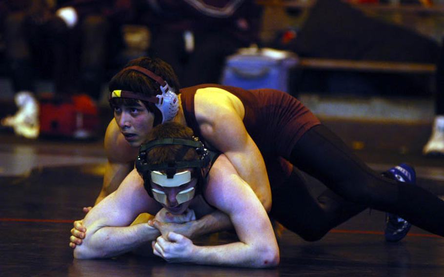 Ryan Edwards of Baumholder, top, controls the right arm of Jason Moose from SHAPE during a match at the DODDS-Europe Northern Sectionals at RAF Lakenheath, England.