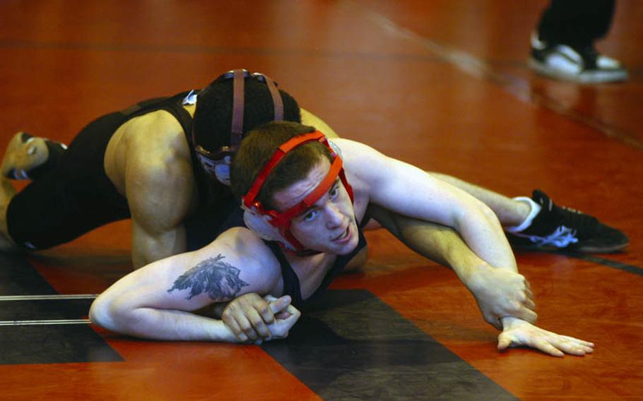 Lakenheath's Tyler Lloyd tries to free himself from the grasp of Adrian Julien during a match at the DODDS-Europe Northern Sectionals at RAF Lakenheath. Lloyd defeated Julien for first place at the sectionals. Last season, Julien defeated Lloyd in the European championship match in the 112-pound class.