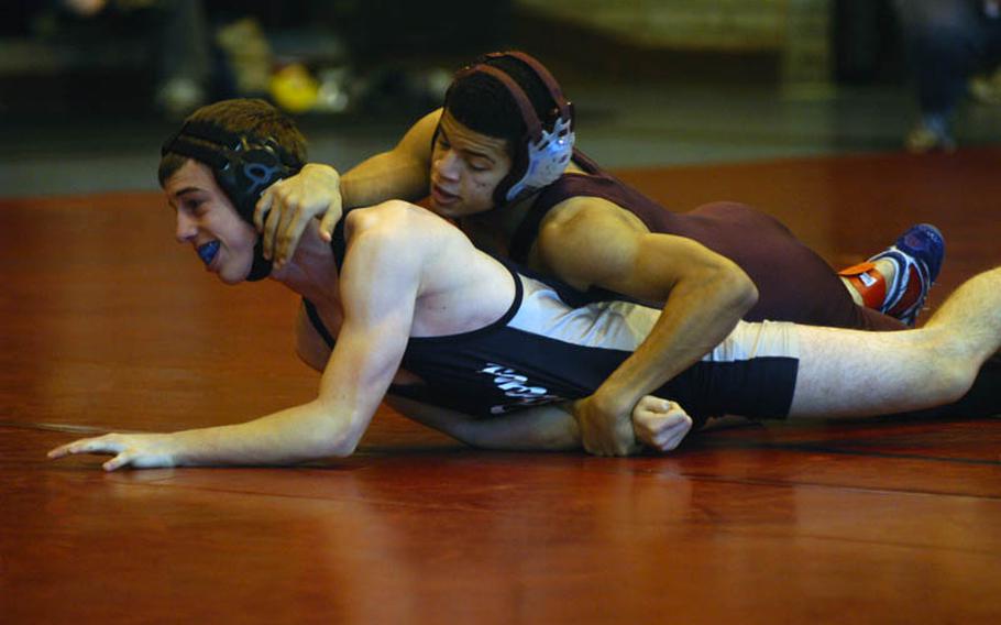 Baumholder's Adrian Julien, top, tries to control Bitburg wrestler Nick Reuter during a 119-pound matcup in the DODDS-Europe Northern Sectionals at RAF Lakenheath, England.