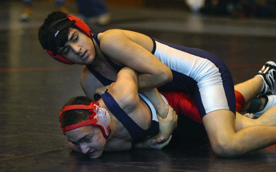 Bitburg wrestler Damian Sotelo appears to have control of Lakenheath's Logan Welle during their match in the 130-pound weight division at the DODDS-Europe Northern Sectionals.