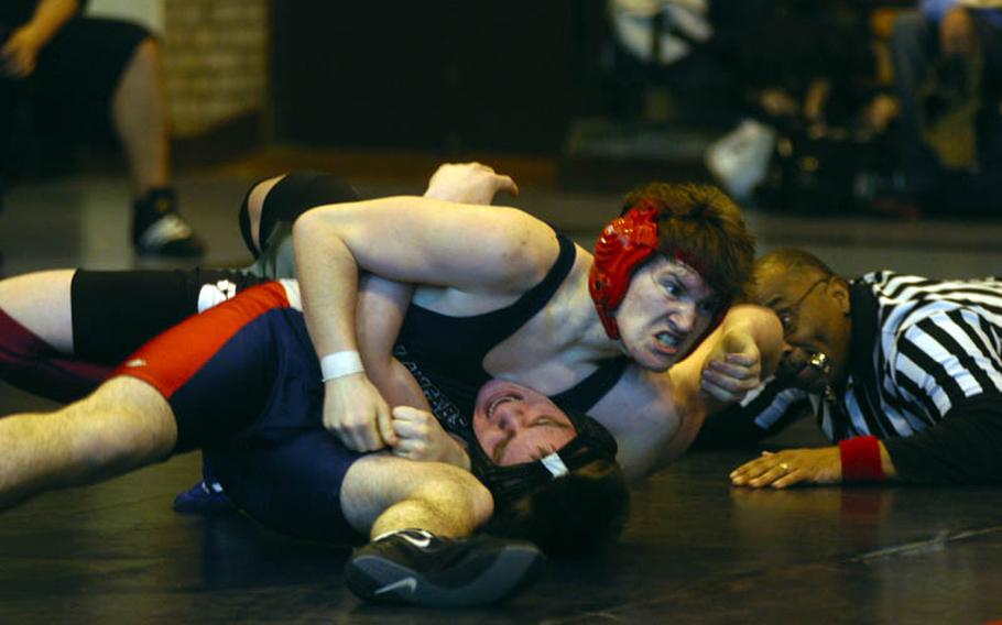 Lakenheath's Daniel Carroll clamps down on the head and arm of AFNORTH wrestler Sean Amidan during a 171-pound bout during the DODDS-Europe Northern Sectionals at RAF Lakenheath, England.
