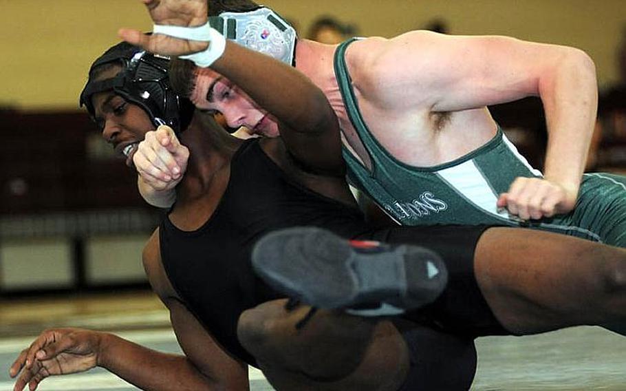 Austin Standridge, right, of Kubasaki gets the upper hand on Richard Castillo of Zama American during Tuesday's 148-pound consolation bout in the 34th Far East High School Wrestling Tournament at Super Gym, Camp Humphreys, South Korea. Standridge decisioned Castillo 2-1 (0-2, 3-2, 3-3 big point).