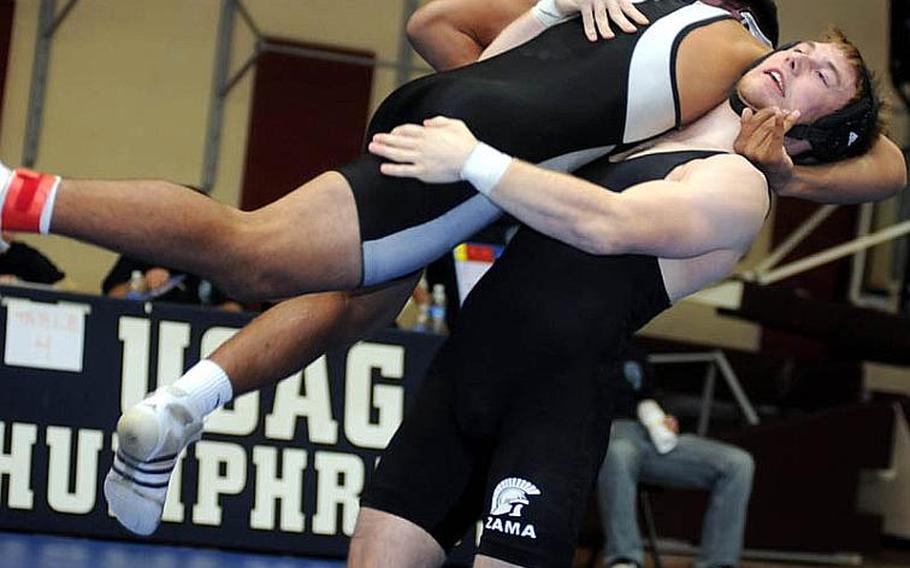 Zama American&#39;s Michael Spencer lifts Father Duenas Memorial&#39;s Davin Cepeda into the air during Tuesday&#39;s 215-pound quarterfinal bout in the 34th Far East High School Wrestling Tournament at Super Gym, Camp Humphreys, South Korea. Two-time reigning Far East gold medalist Spencer pinned Cepeda in 3 minutes, 11 seconds.