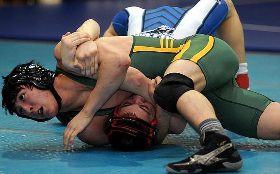 Robert D. Edgren&#39;s Keith Johnson locks in a head-in-arm hold on Seoul American&#39;s Robert Rhea during Tuesday&#39;s 129-pound quarterfinal bout in the 34th Far East High School Wrestling Tournament at Super Gym, Camp Humphreys, South Korea. Johnson pinned Rhea in 3 minutes, 28 seconds.